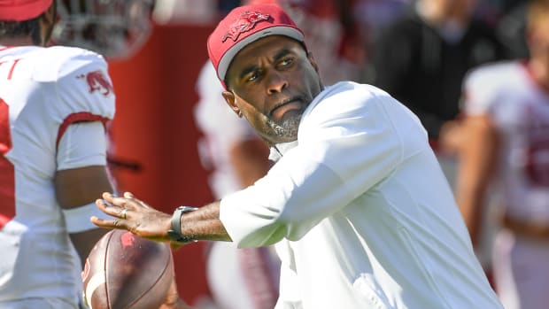 Arkansas assistant Marcus Woodson works with his players prior to the Alabama game.